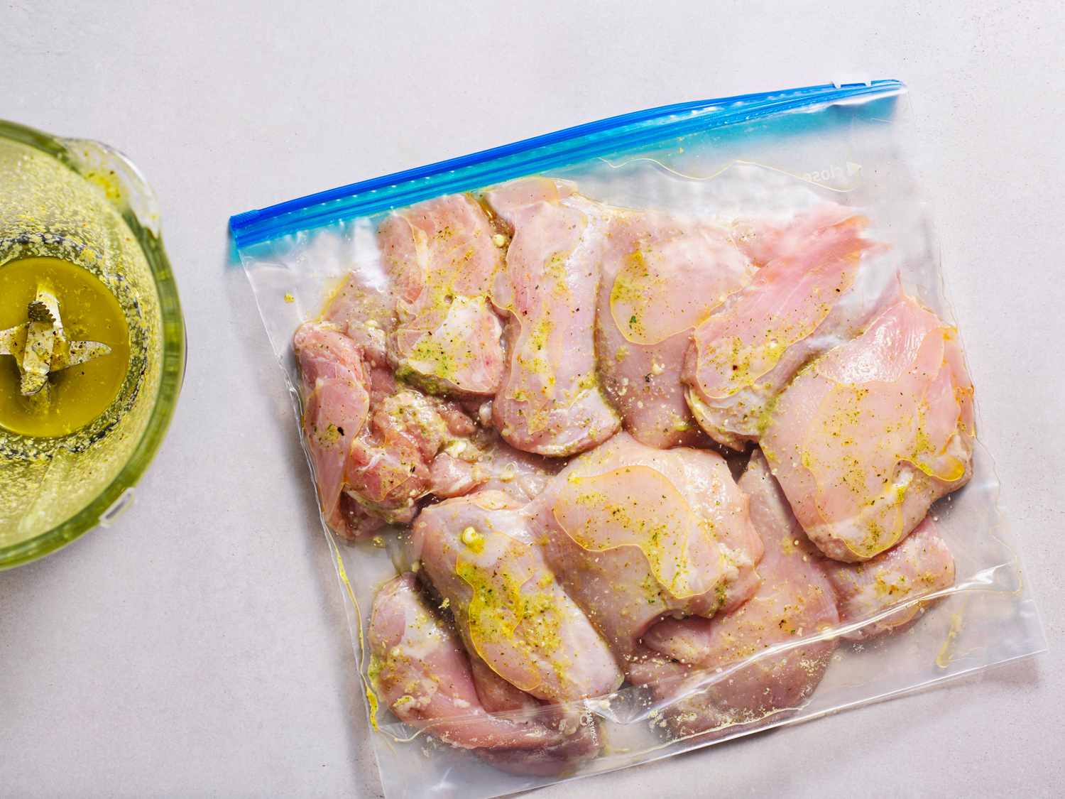 chicken covered in marinade in a zipper-lock bag