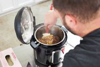 A person stirring food in an Instant Pot.