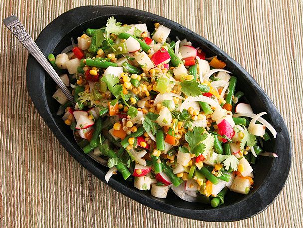 Overhead view of the finished Charred Corn, Radish, Jicama, and Green Bean Salad With Lime Dressing, ready to serve.