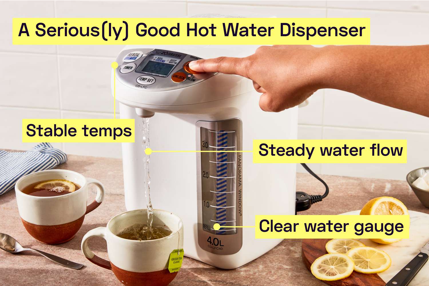 A person dispensing water into a cup with a hot water dispenser.