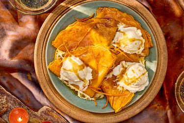 Plate of crepes topped with whipped cream and sauce