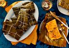 Plates of hallacas wrapped and unwrapped traditional Venezuelan tamales