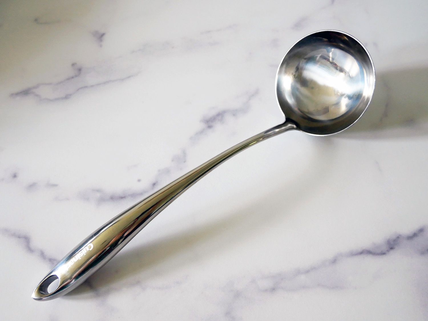 The cuisinart ladle on a marble countertop