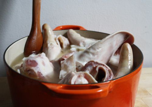 Pork scraps in a soup pot. 