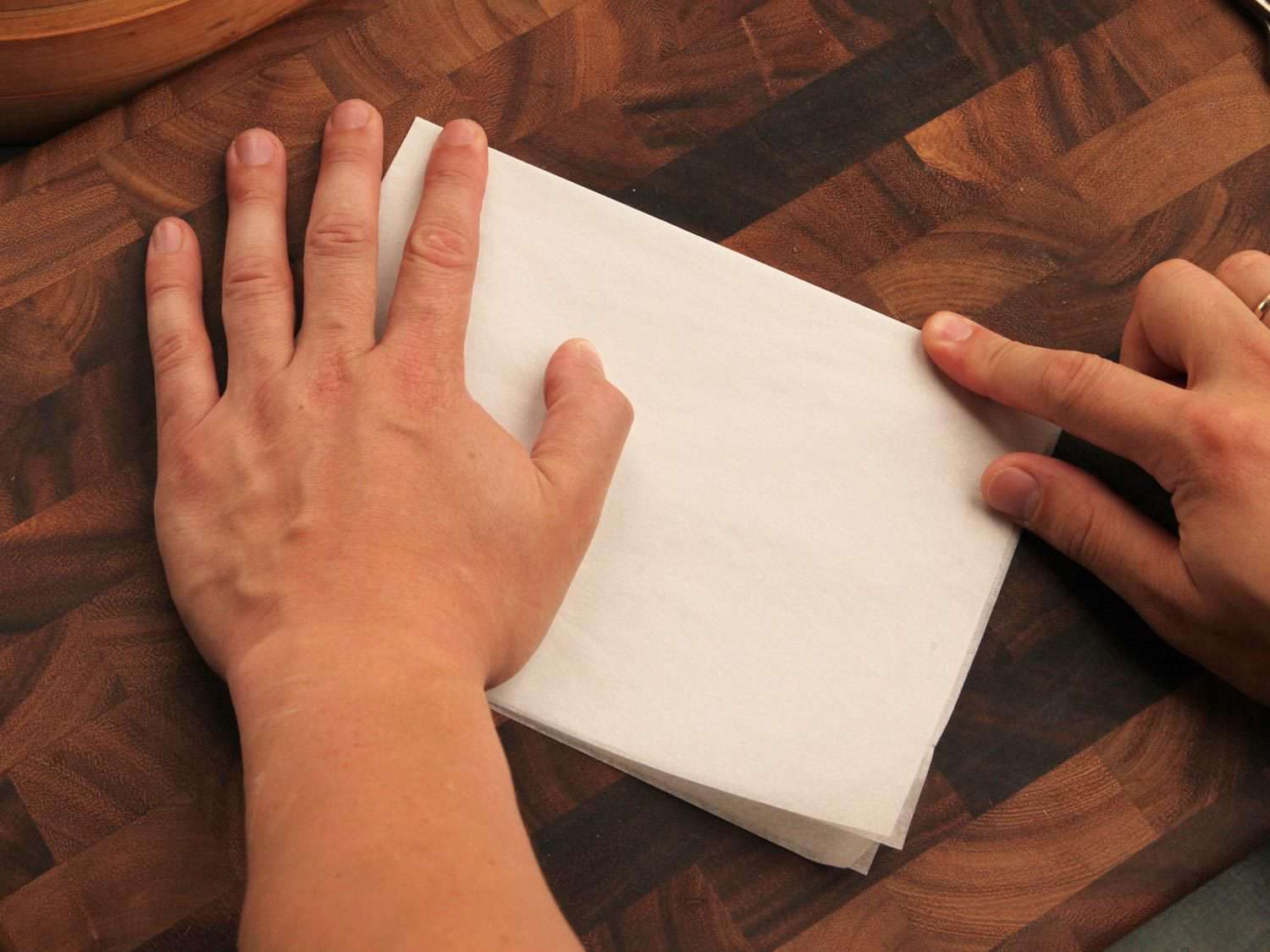 Folding parchment paper in quarters.