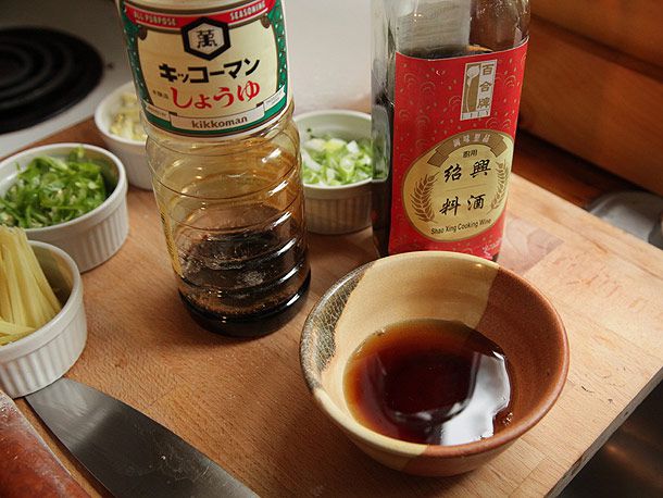 Soy sauce, cooking wine, and chopped aromatics ready for making Cantonese-style lobster.