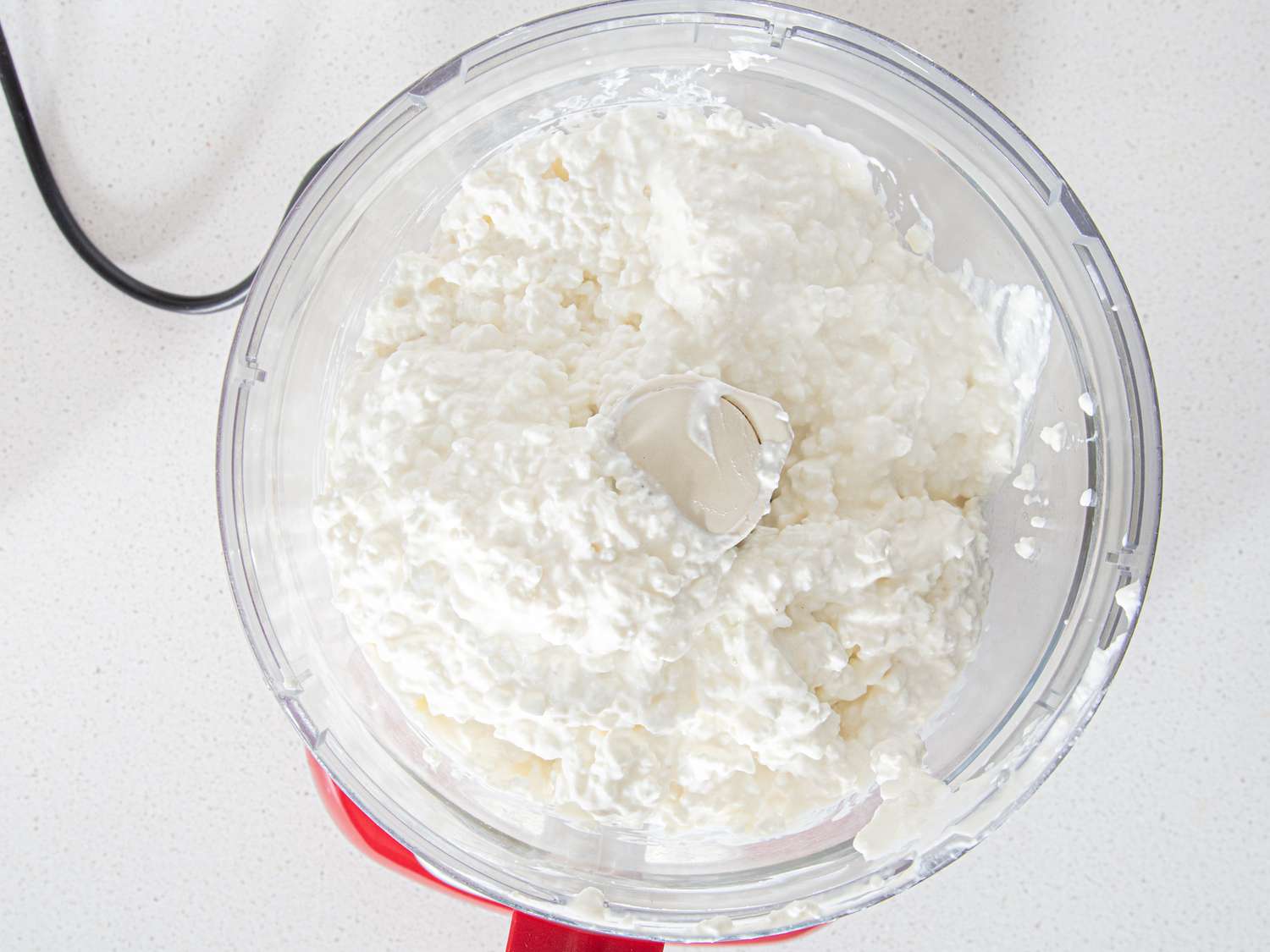 Photo of cottage cheese in a food processor.