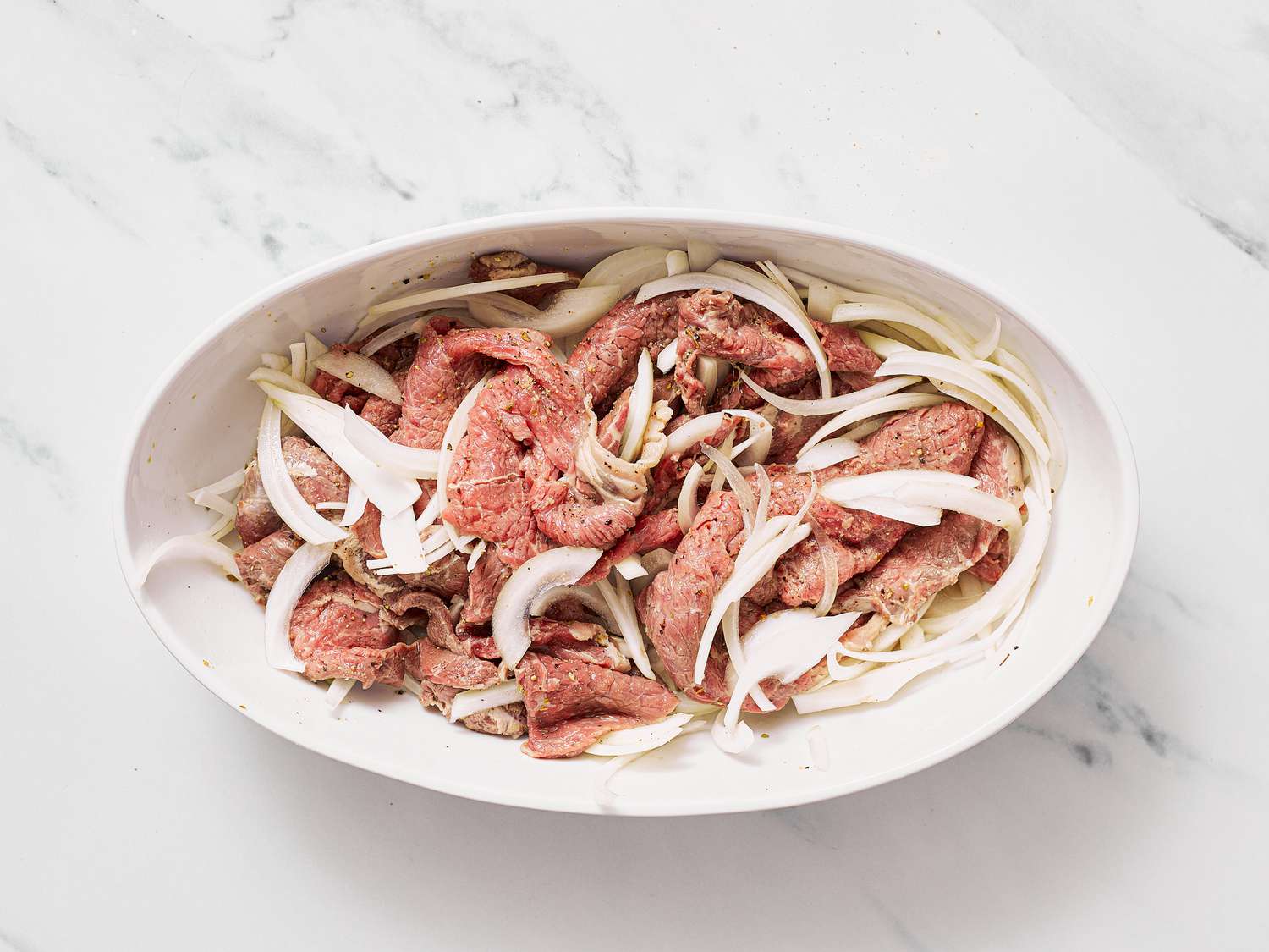 Dish with thinly sliced meat and onion
