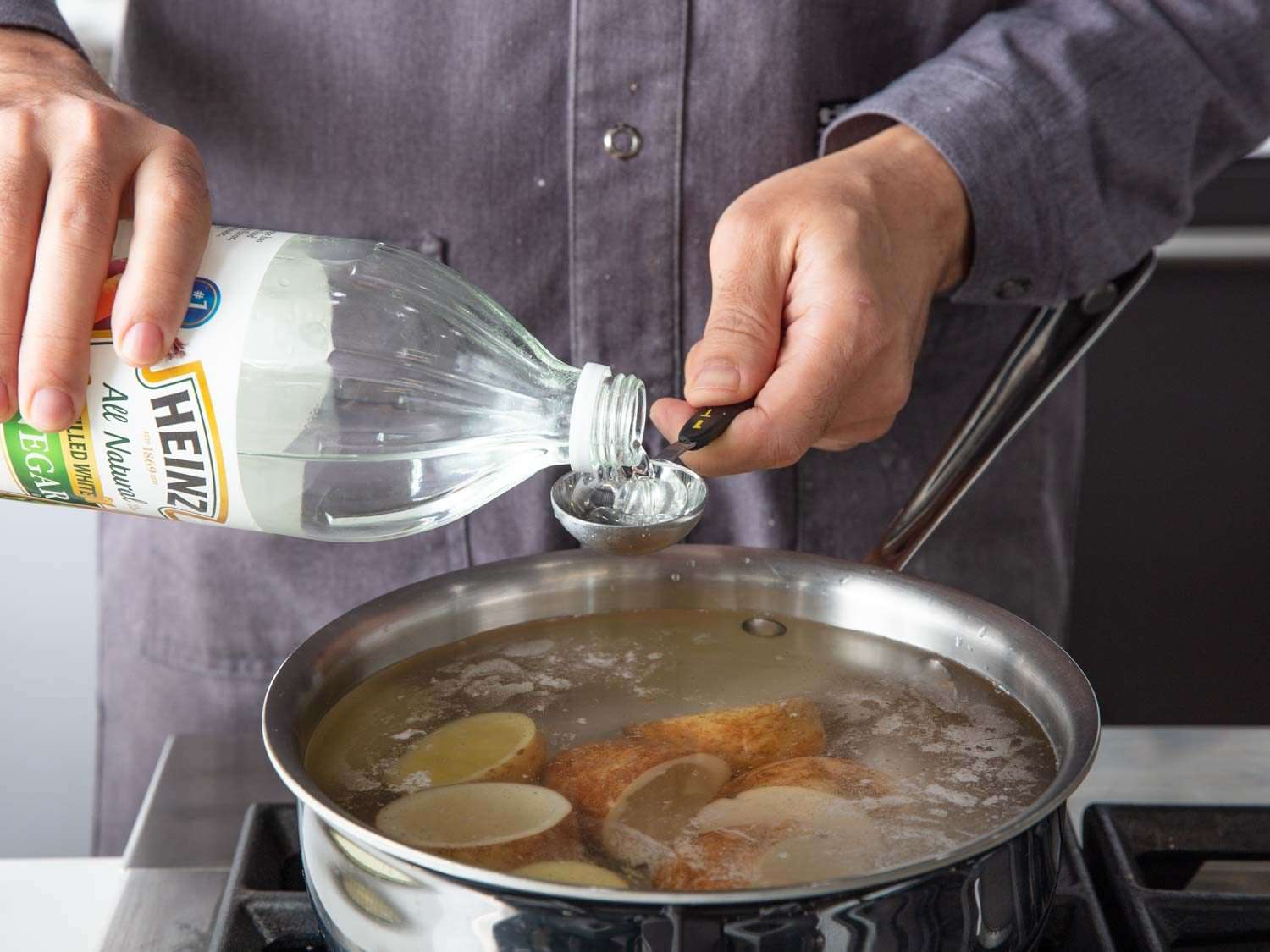 Attempting Serious Eats' French fry method using potato skin cups by boiling the potatoes first with salty and vinegary water
