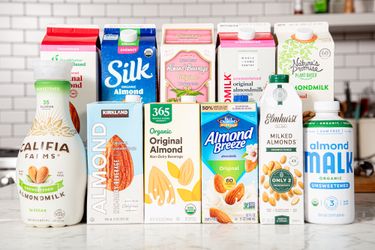 A variety of almond milk brands displayed on a counter