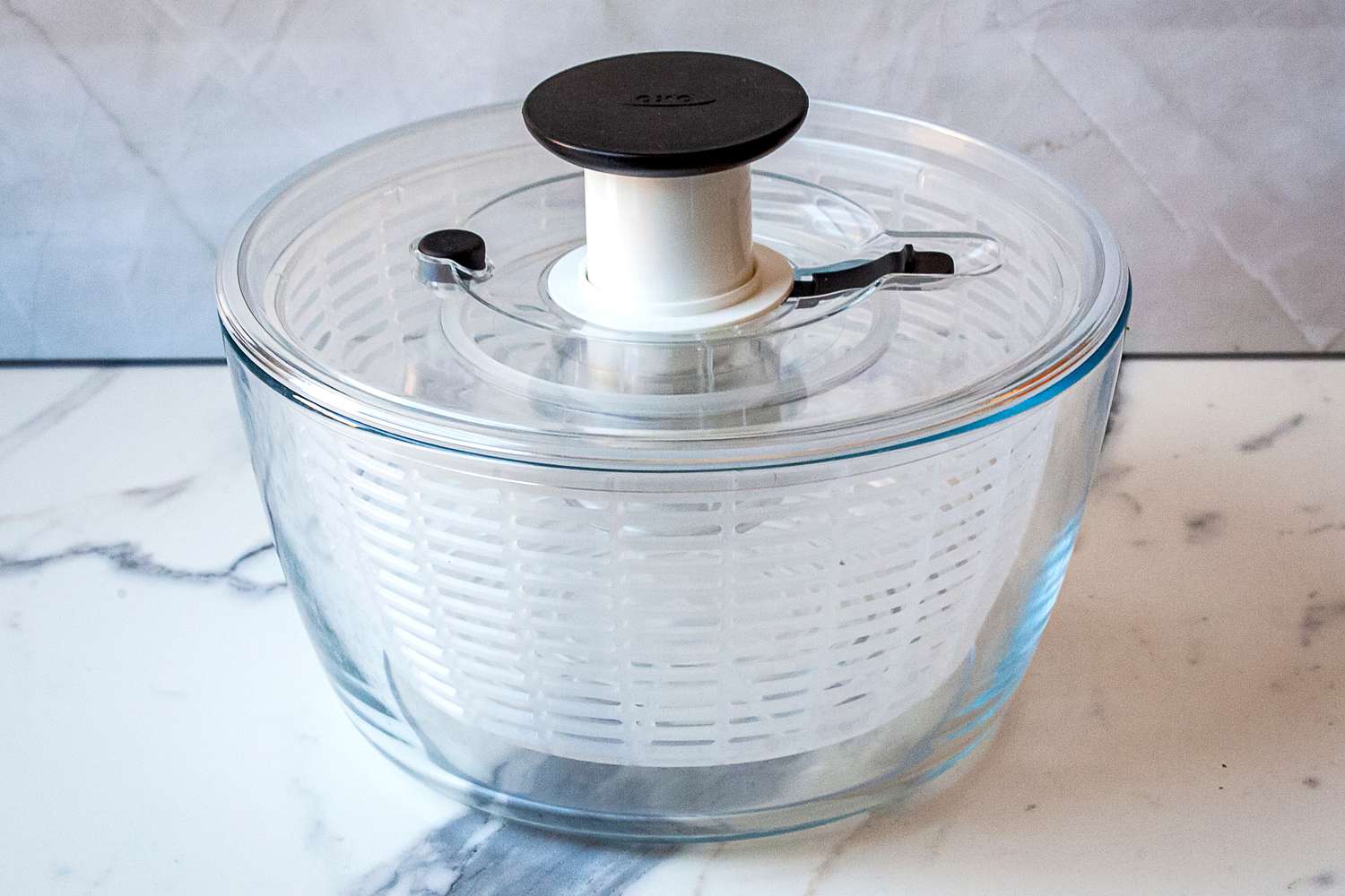 the oxo glass sald spinner on a marble surface