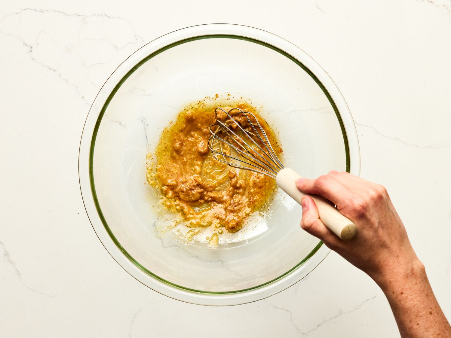 Overhead view of whisking together wet ingredients for dressing