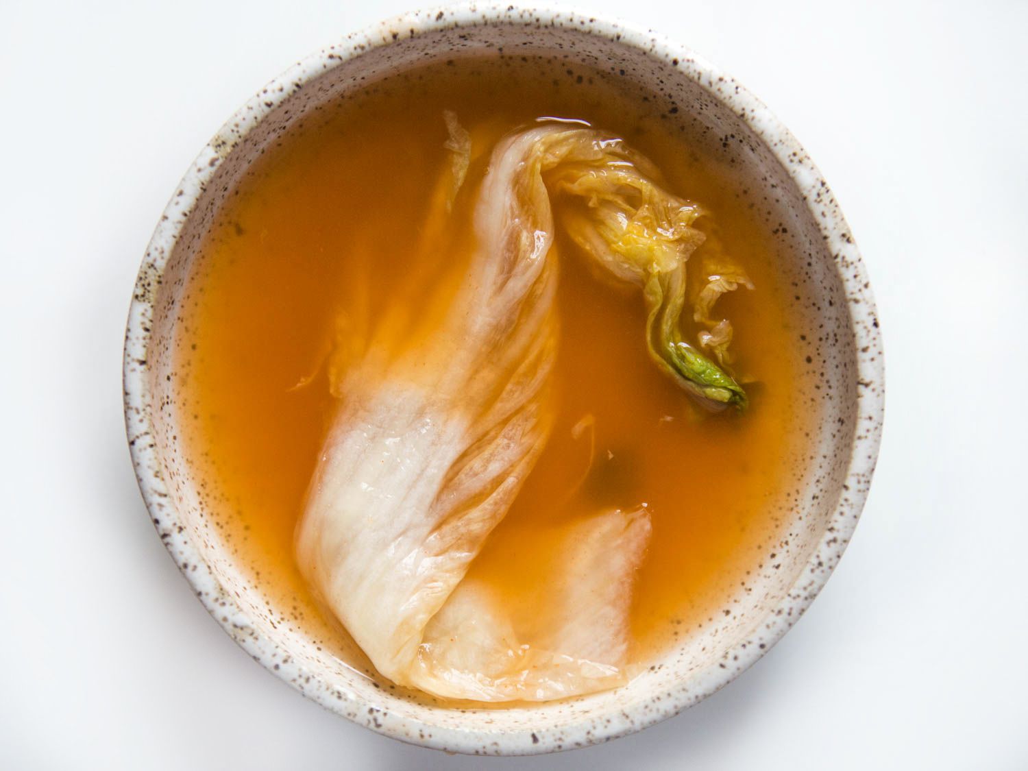 Kimchi in a bowl with broth.