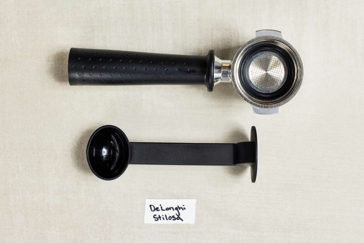 Parts of the portafilter for the De'Longhi Stilosa Espresso Machine on a table