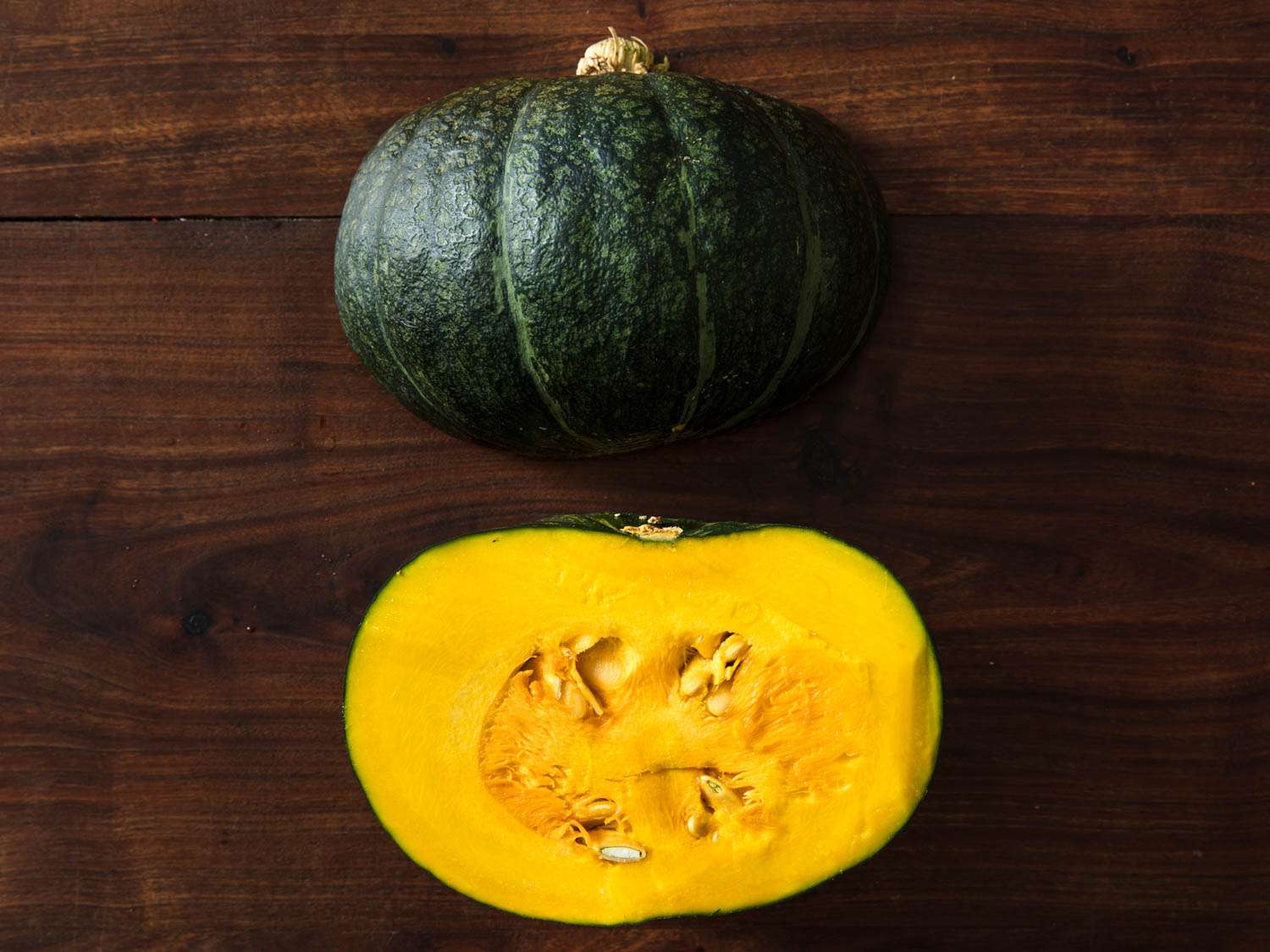 Kabocha squash halved and displayed cut side down and cut side up