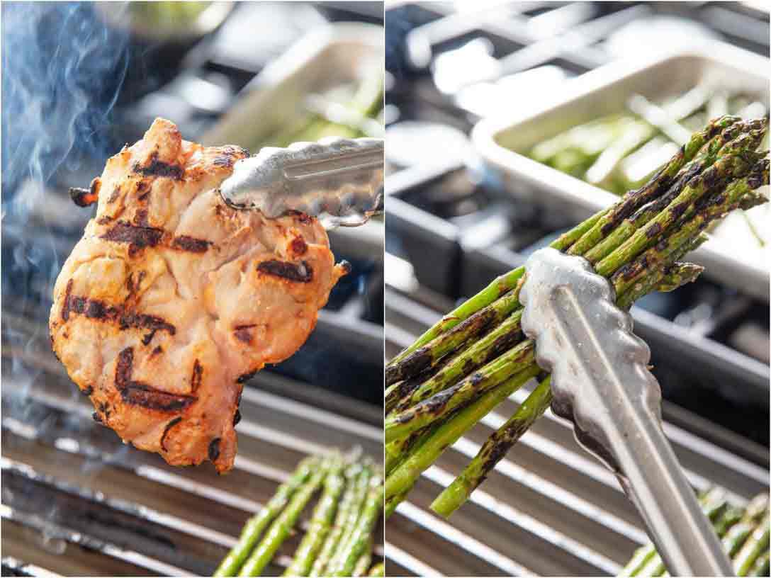 This image shows grilled chicken and asparagus being held aloft by tongs; it was all cooked on the GrillGrate, and shows even browning all over.