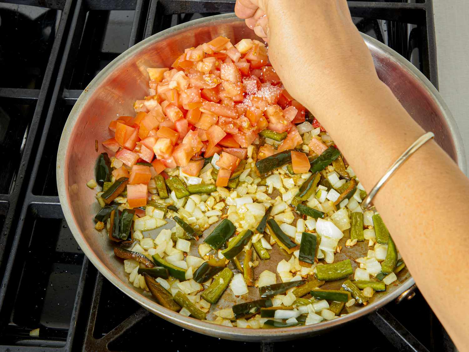 Overhead view of salting tomatoes
