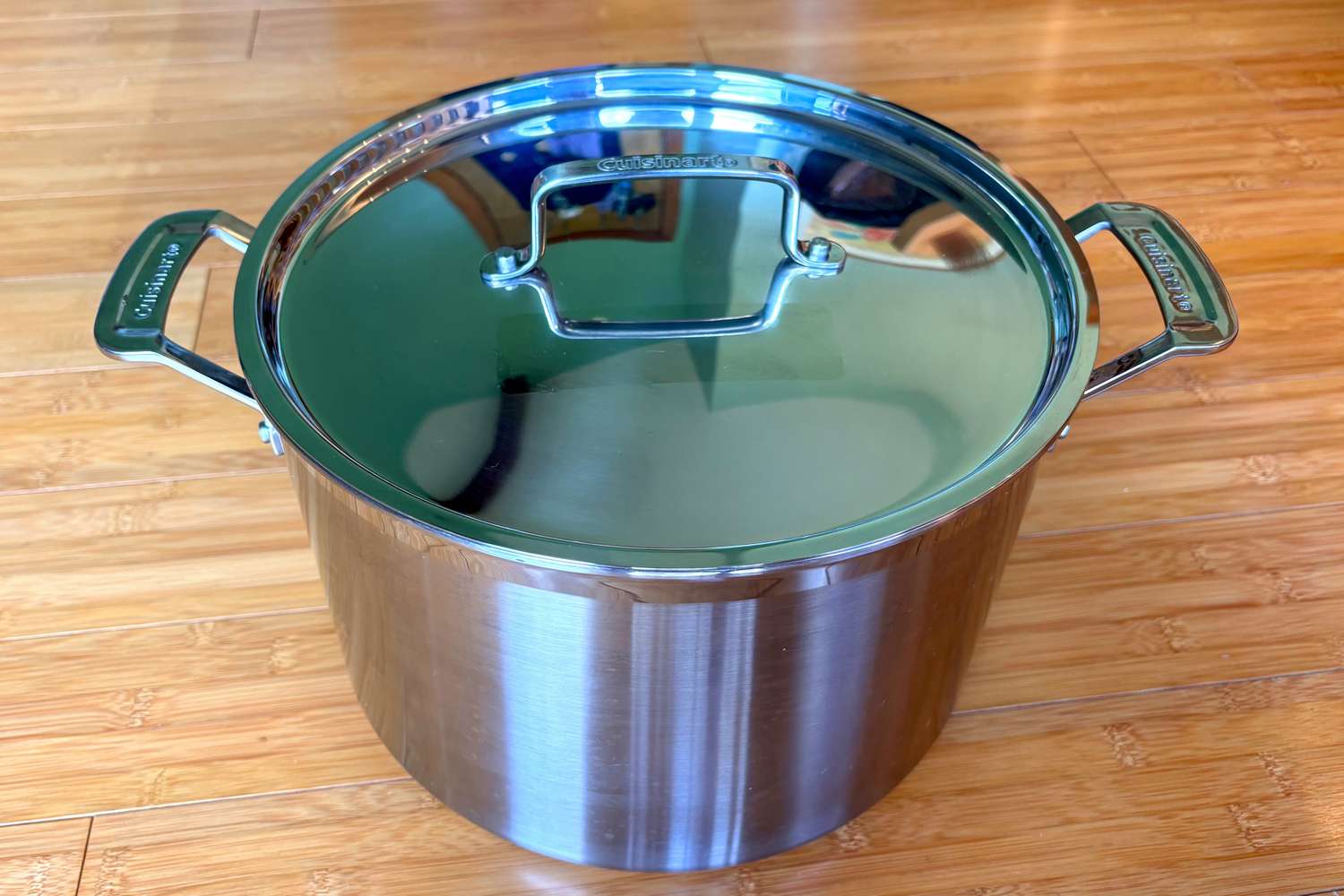 The Cuisinart stainless steel stockpot on a wooden countertop.