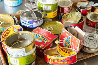 Empty cans of tuna in oil on a sheet pan 