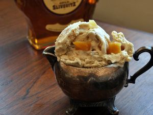Lemon, Honey, and Brandy (or Guggle Muggle) Ice Cream, served in a pewter cream pitcher. A bottle of Slivovitz brandy is in the background.