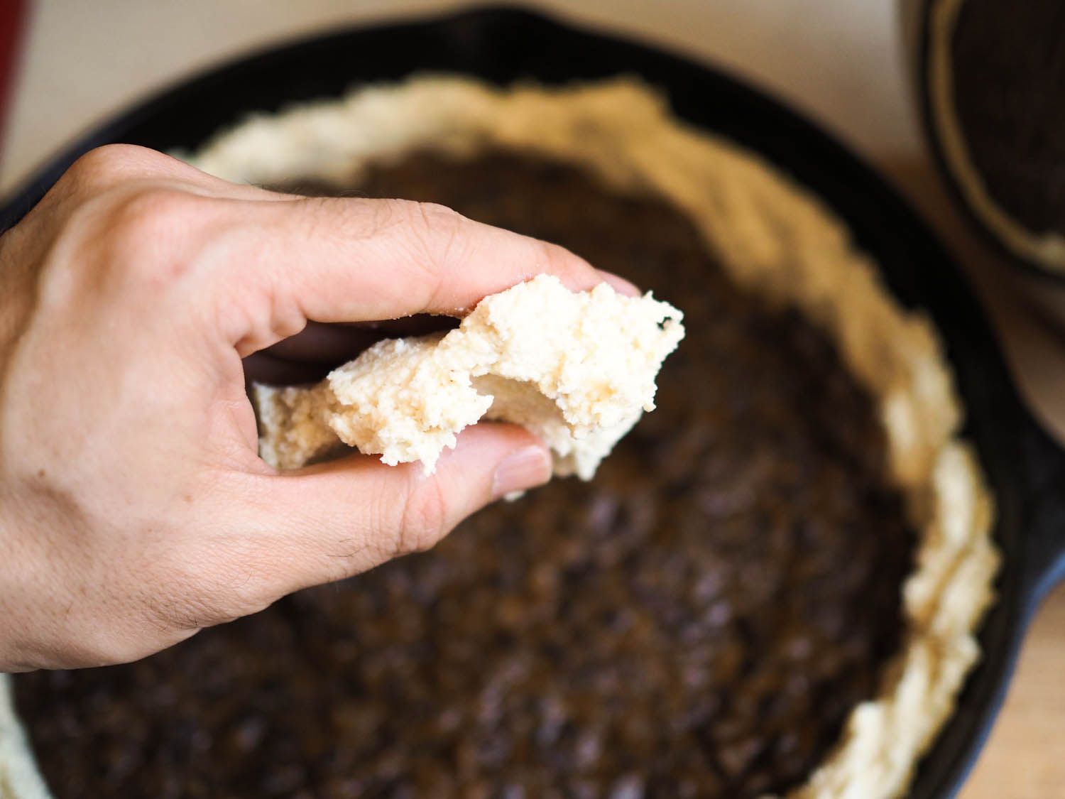 Author holding a flattened portion of masa dough.