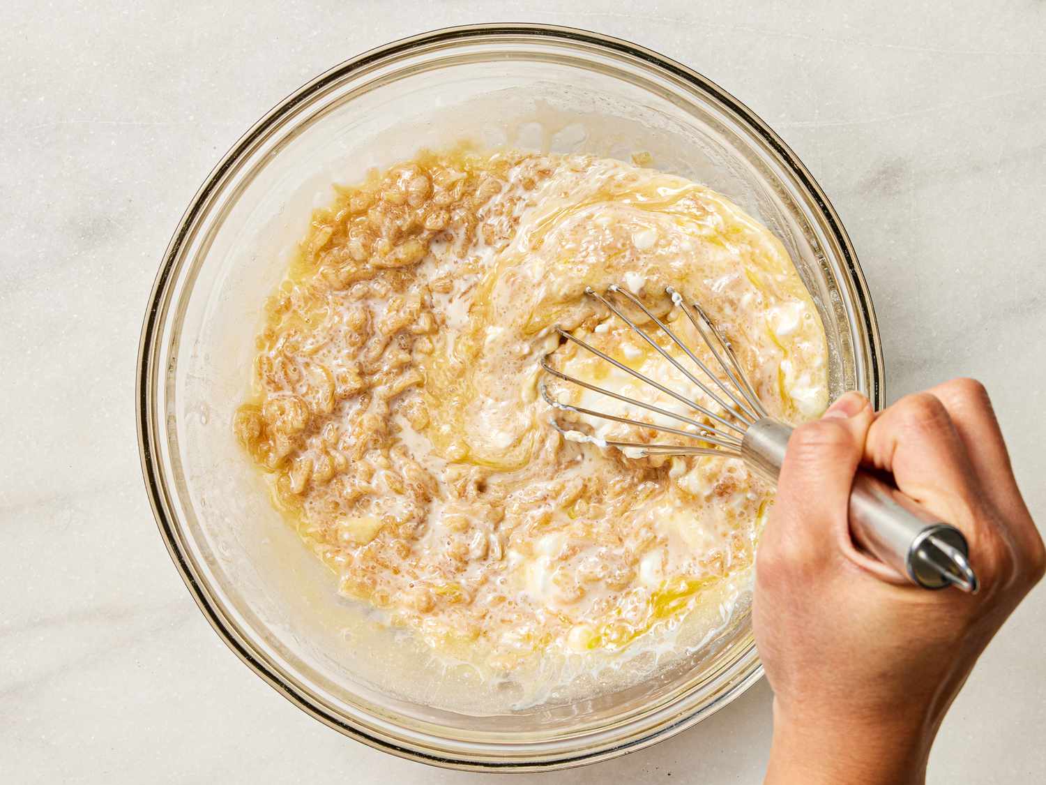  eggs, milk, cream, and apple mixture whisked together in bowl