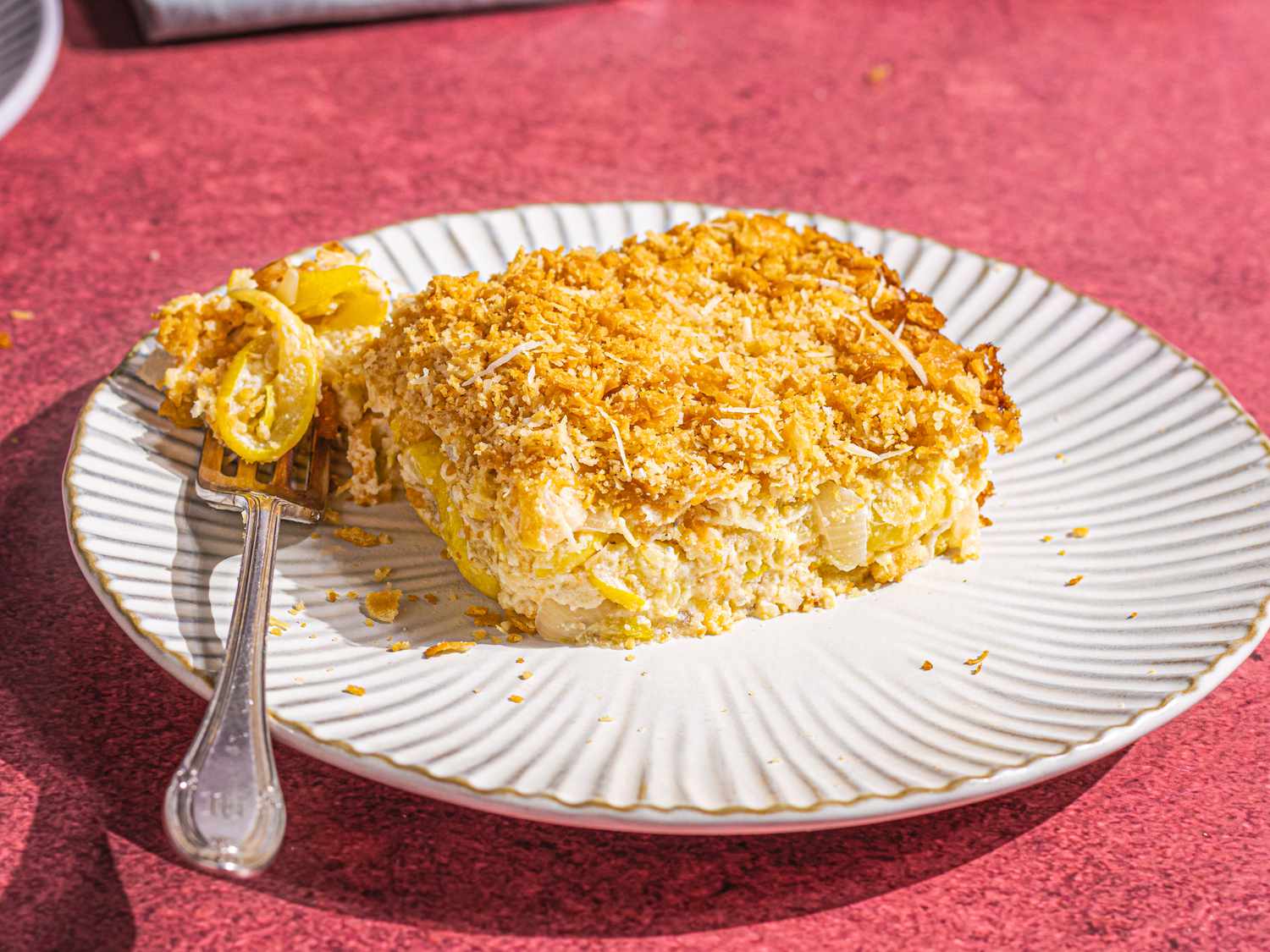A square of golden yellow squash casserole.