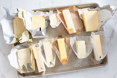 A sheet tray packed with bars of unsalted butter.
