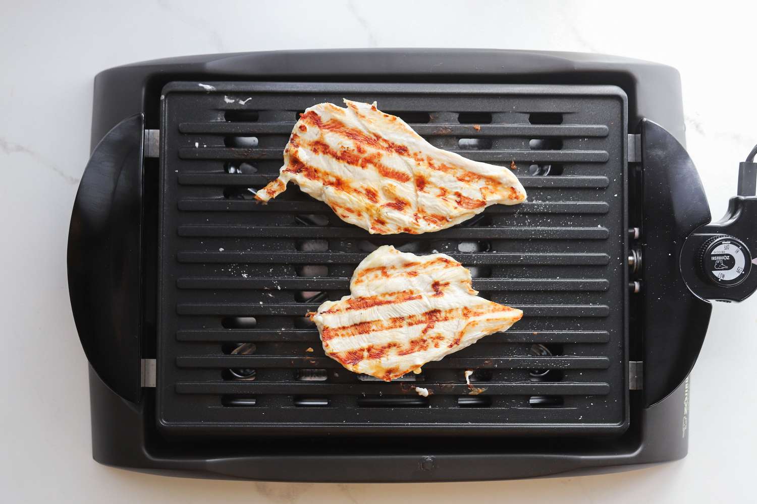 Chicken breasts grilling on the Zojirushi indoor grill