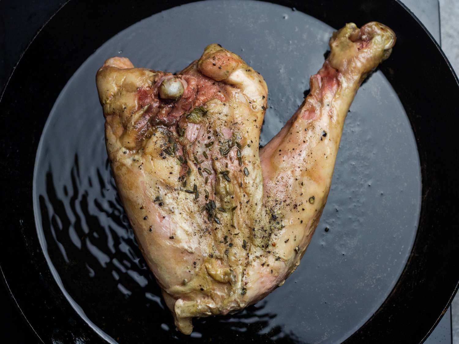 Turkey leg cooking in shimmering oil.