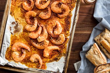 A foil-lined sheet pan of quick broiled shrimp cooked in beer and harissa. 