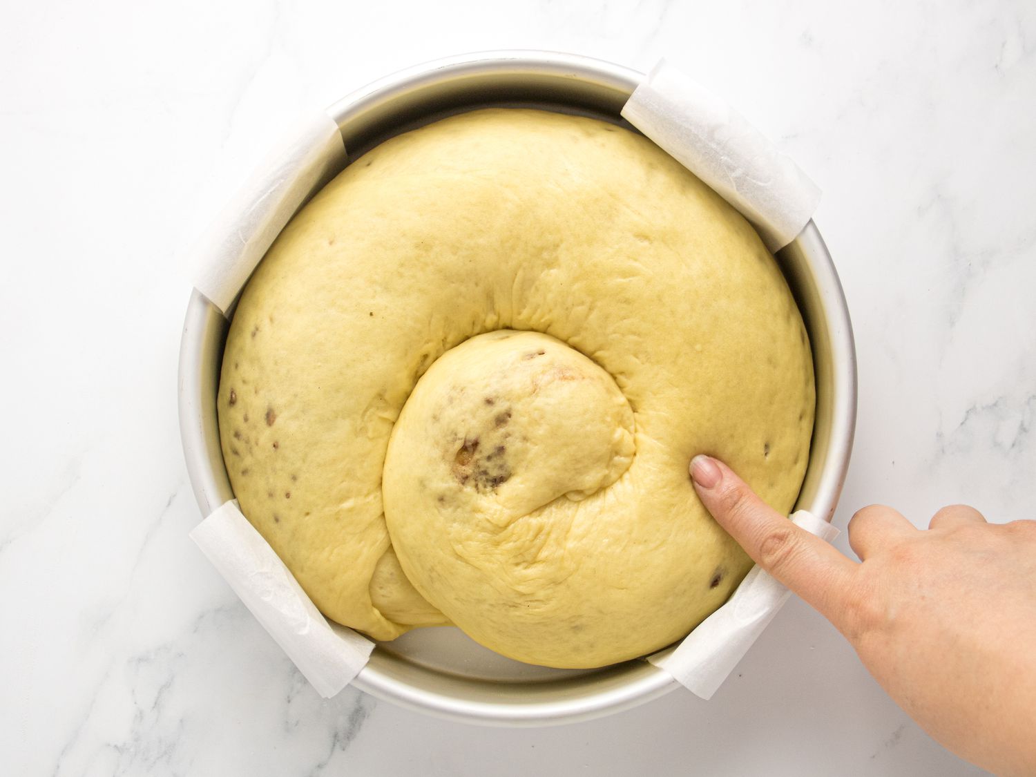 finger poking proved dough to show it bouncing back 