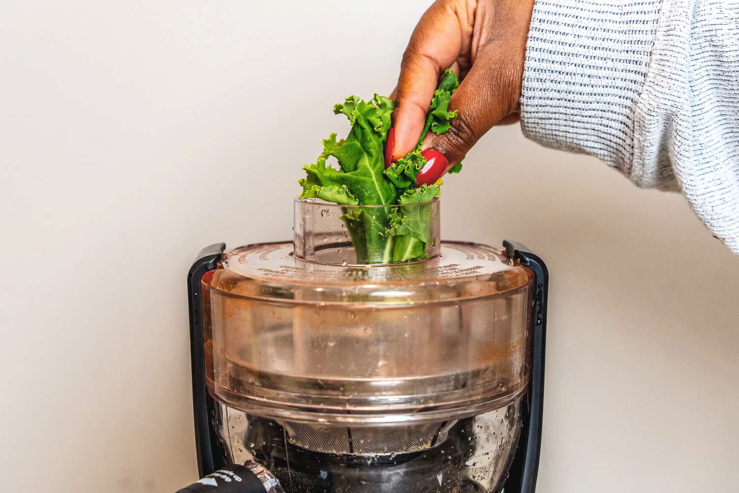Kale being juiced in the Magic Bullet juicer