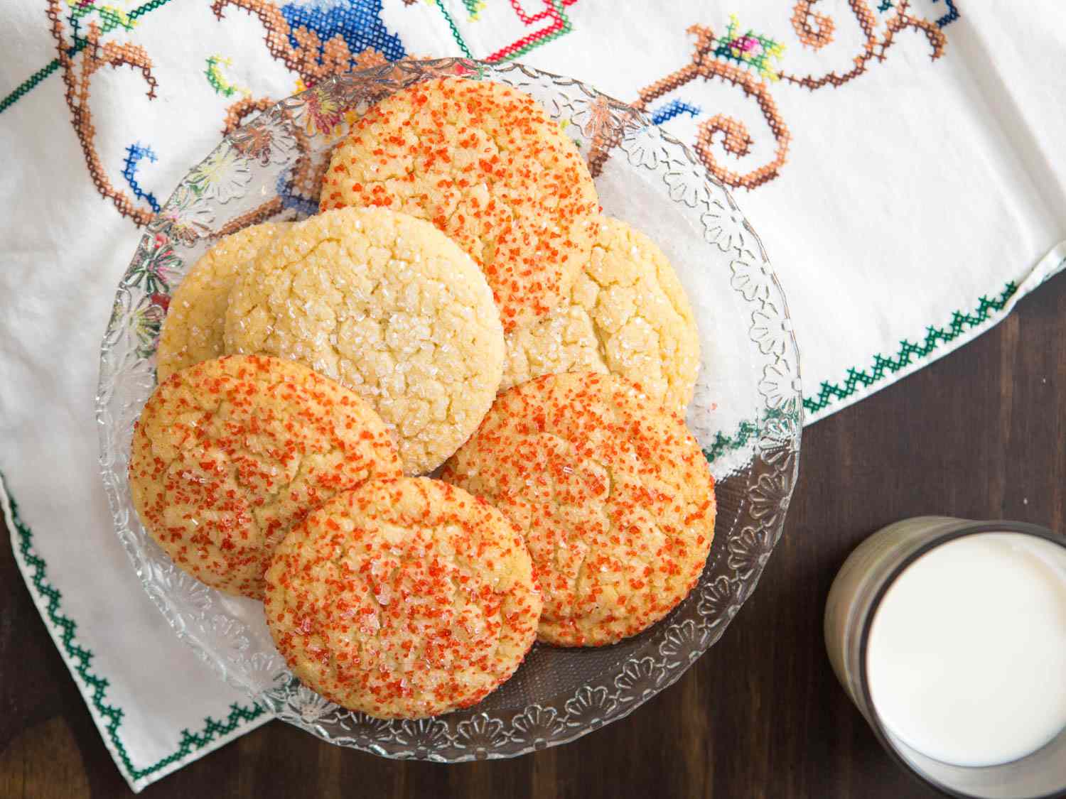 Overhead of a plate of soft and chewy sugar cookies on a glass plate.