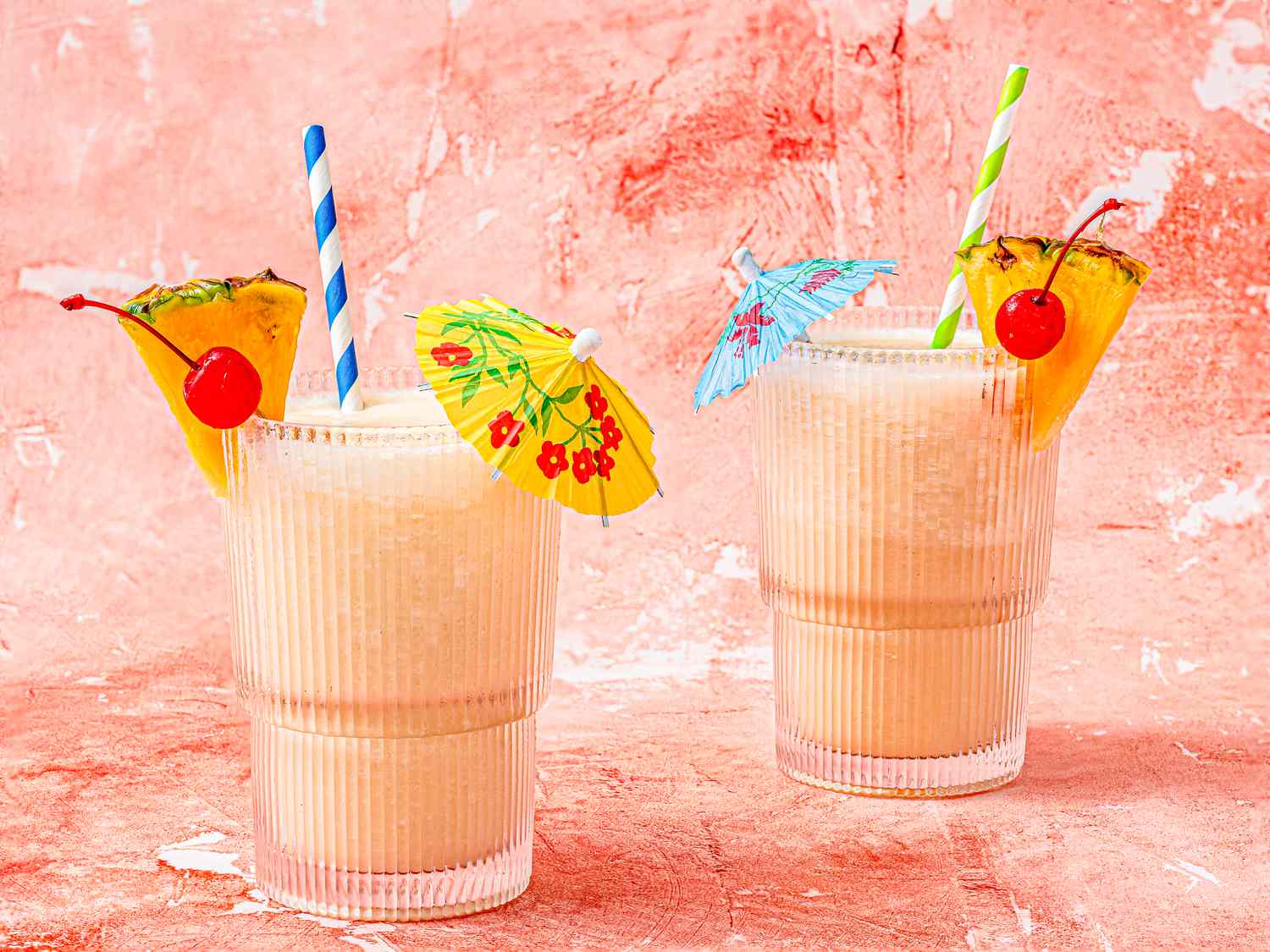 Two Pina coladas on a pink background