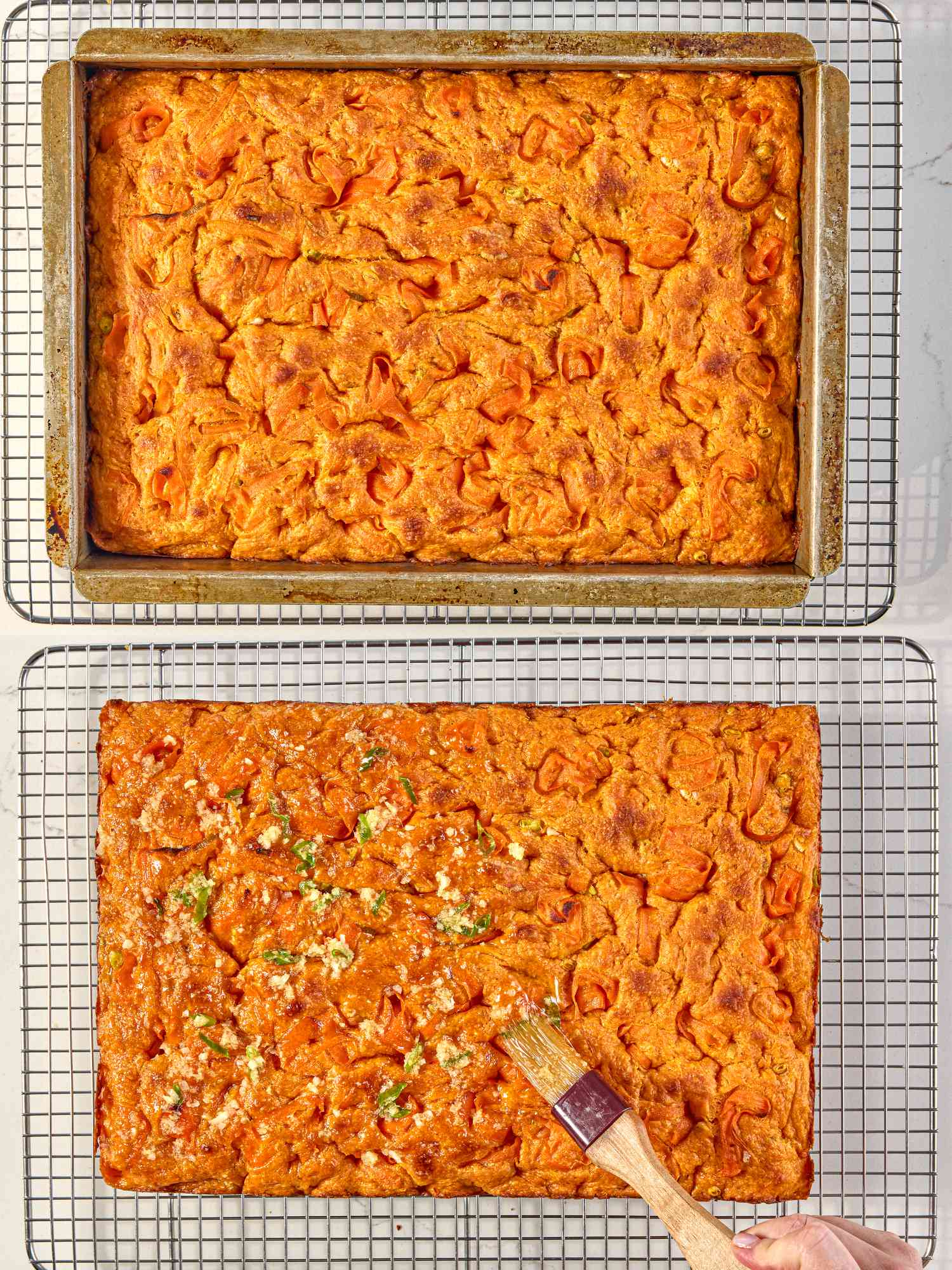 Carrot focaccia bread on cooling racks, one in a pan and the other being brushed with a garlic mixture