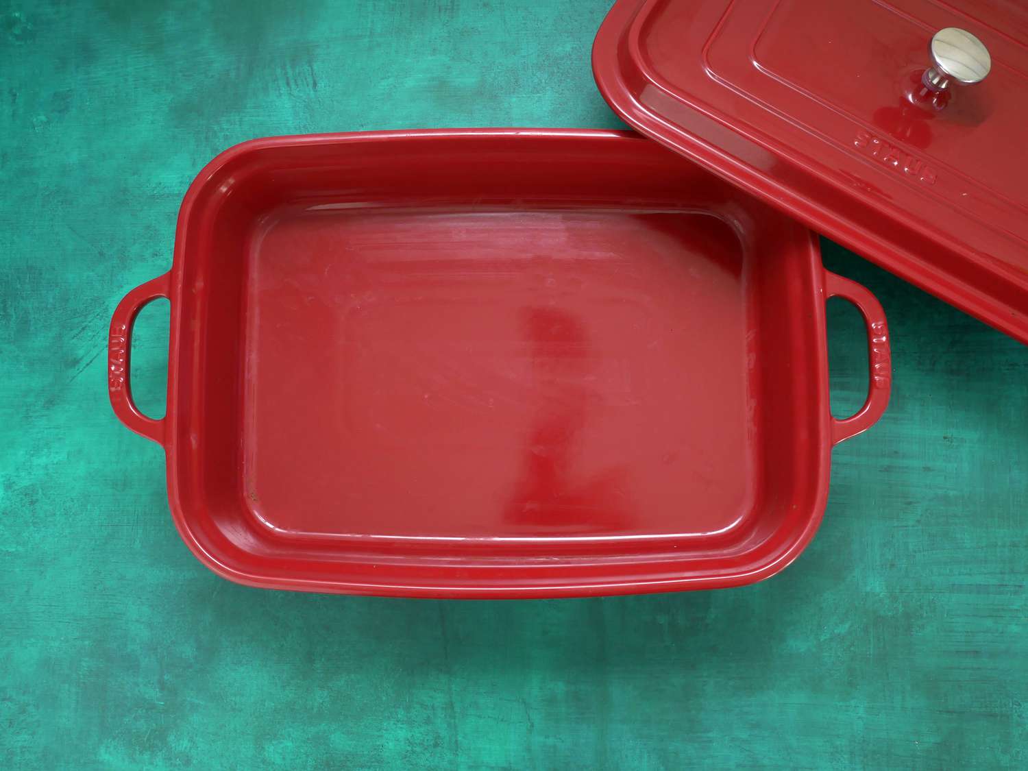 Staub Stoneware Rectangular Baker on a green backdrop