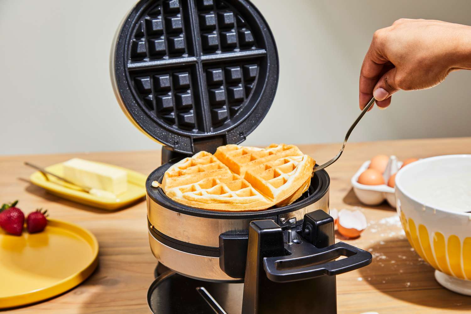 A waffle being lifted from Cuisinart WAF-F4 Double Flip Belgian Waffle Maker