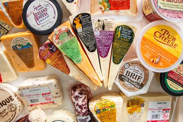 Variety of packaged cheeses displayed together sourced from Trader Joes