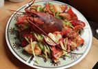 A plate of Cantonese-style lobster with ginger and scallions.