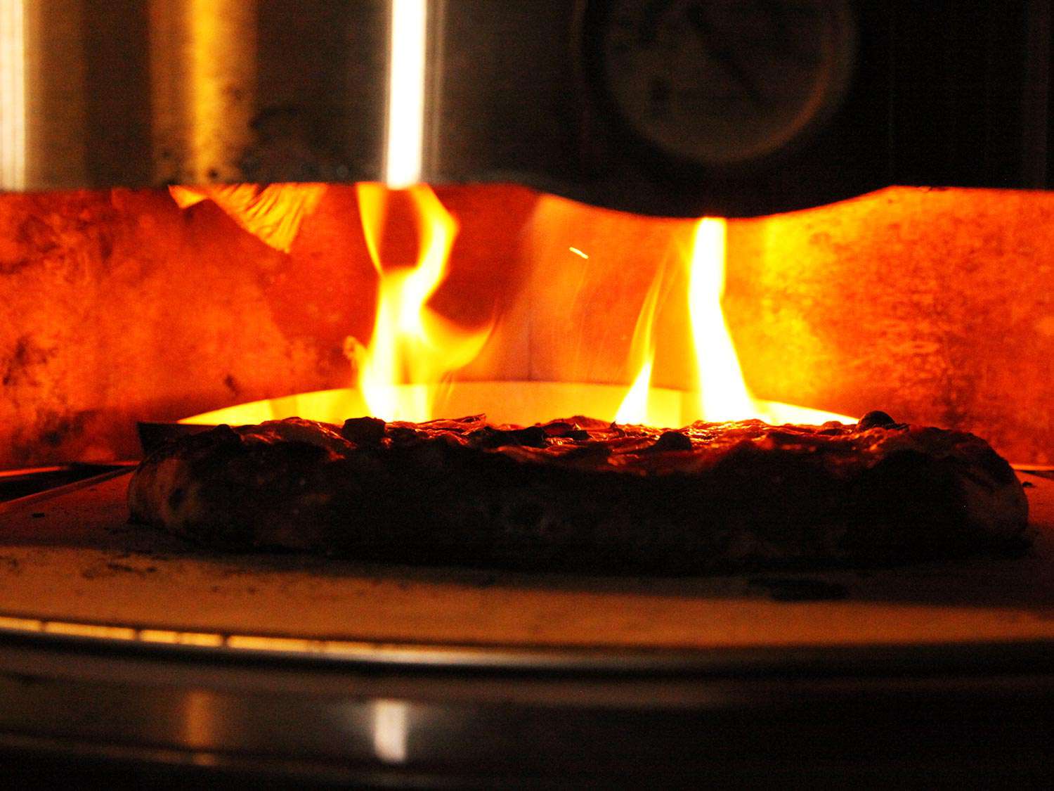 A pizza in an oven, demonstrating cooking via convection and radiation.