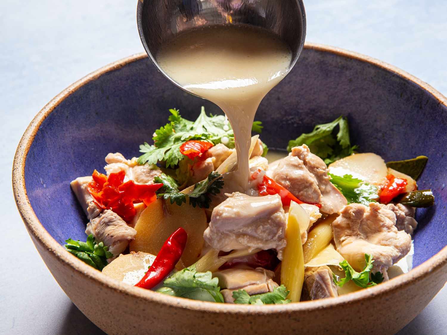 Soup being laddled into a bowl