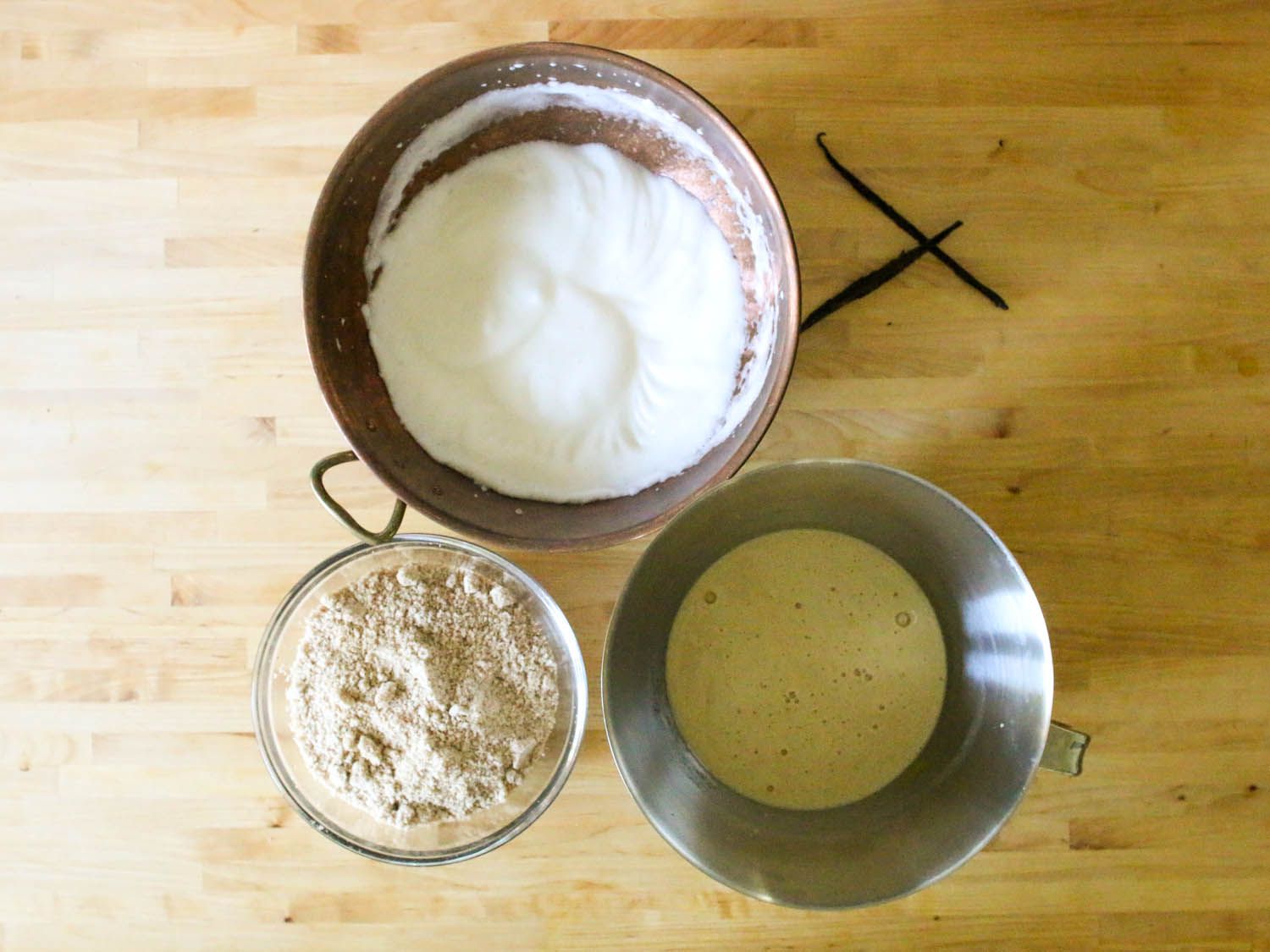 Some of the ingredients for the cake in bowls on a wooden surface.