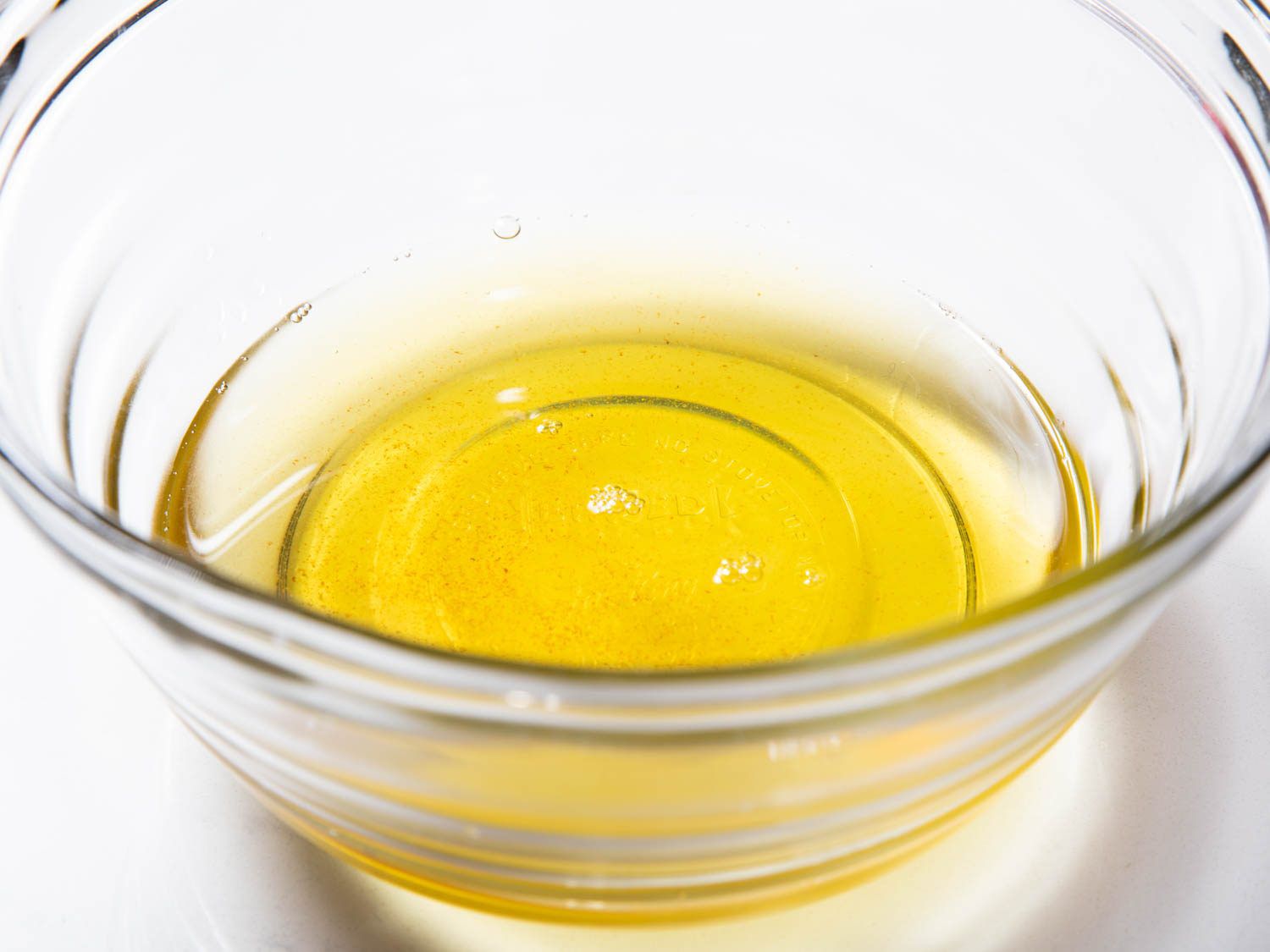 Glass bowl of rendered duck fat.