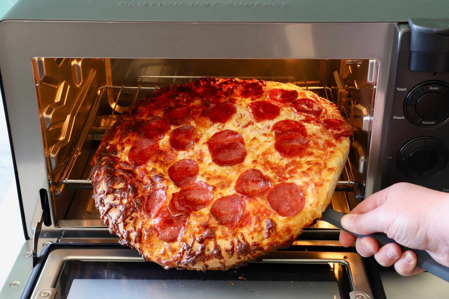 removing a frozen pizza from the tovala oven