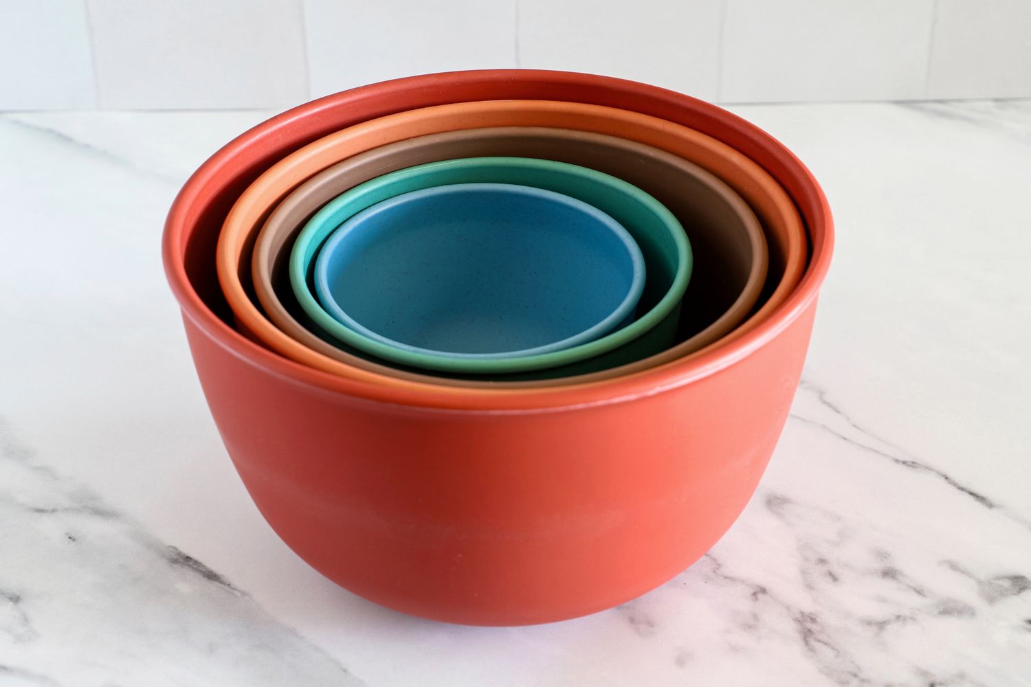 A set of Bamboozle nesting mixing bowls in various sizes arranged on a marble surface