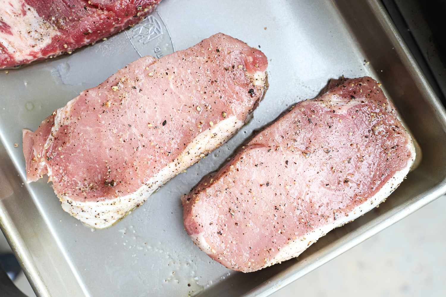 Two raw pieces of Good Chop meat on a metal tray