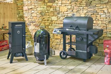 There smokers on an outdoor patio.