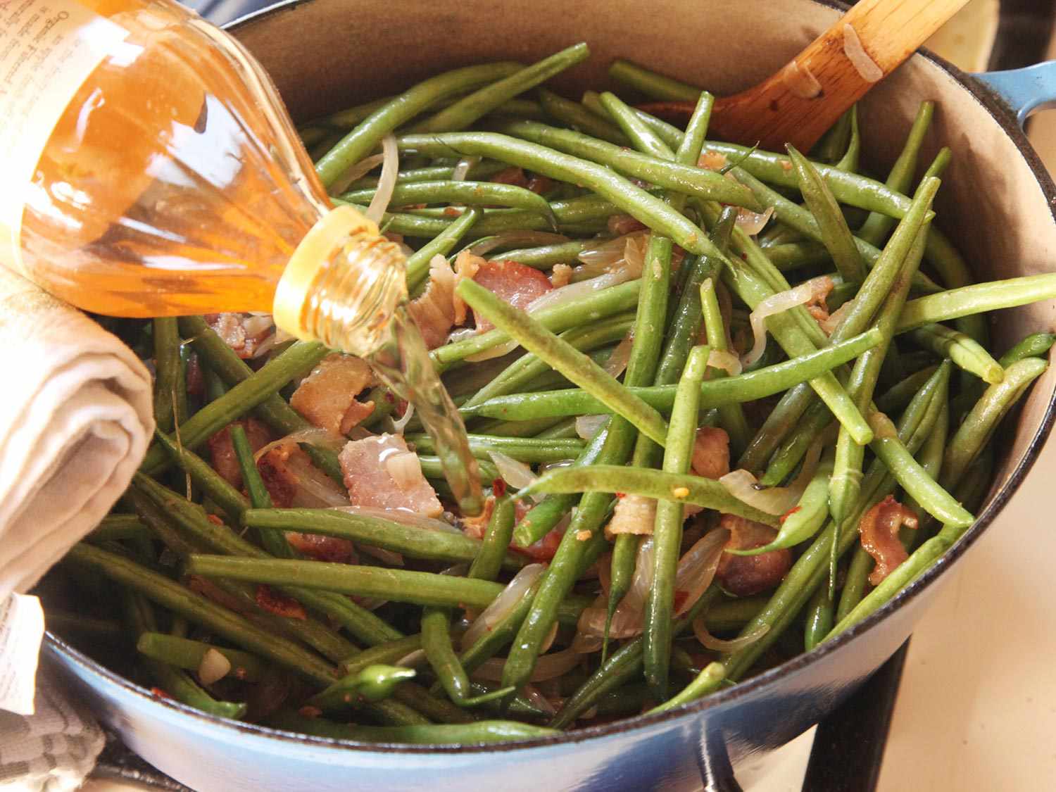 Adding vinegar to green bean mixture in Dutch oven