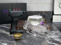 the flavour blaster mini with a popped bubble on a coupe glass